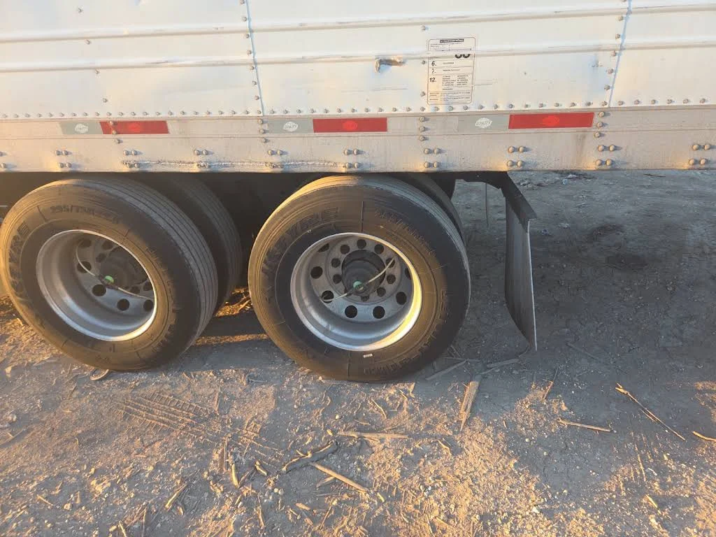 Trailer wheels and tires beside the repair area