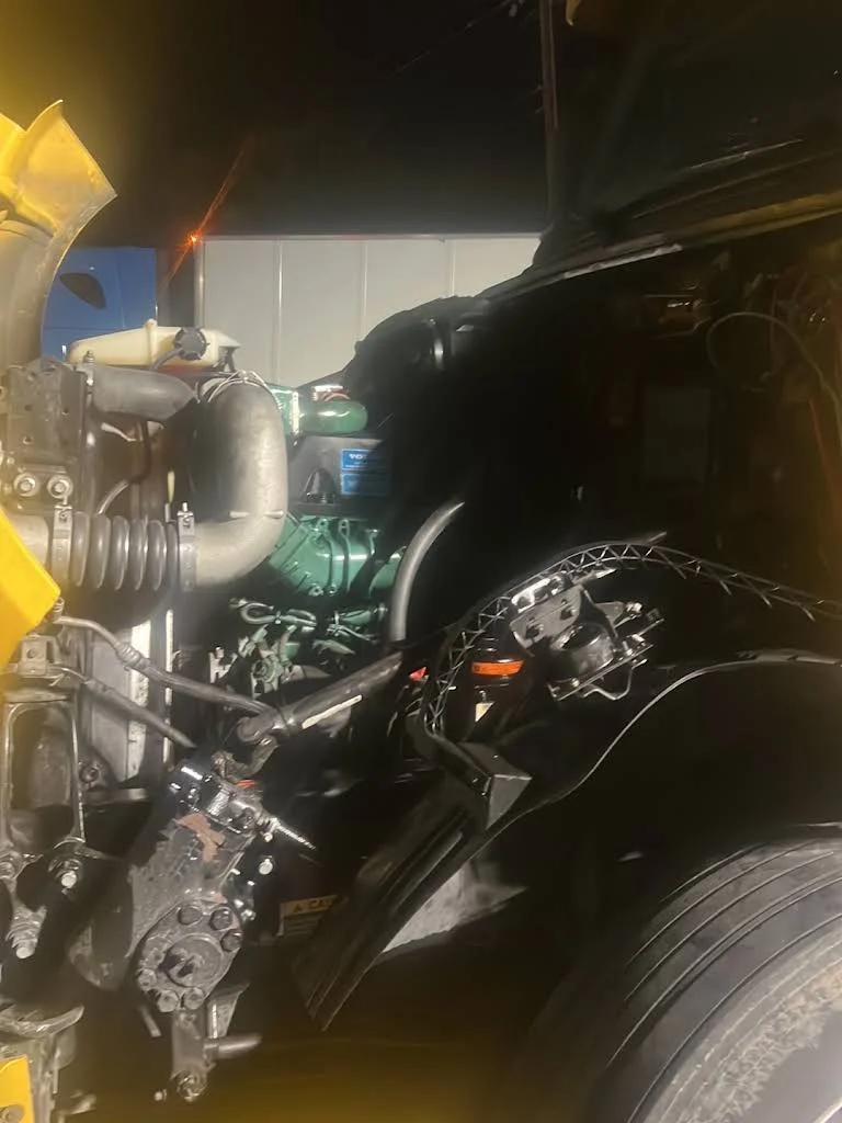 Truck engine work illuminated at night