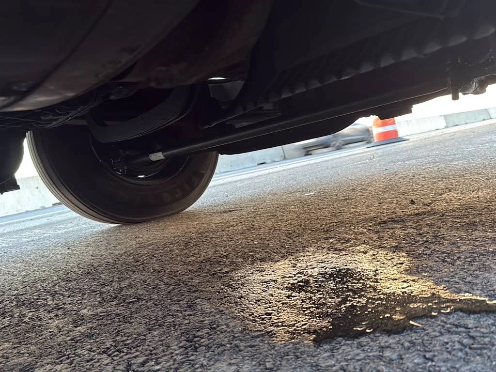 Truck undercarriage and ground beneath the vehicle